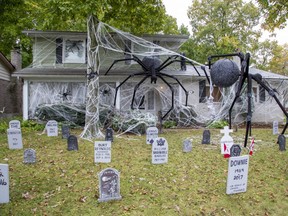 Decorations of large spiders and celebrity tombstones at 45 Blue Ridge Cres., are a labour of love for Dan Earle. (DEREK RUTTAN, The London Free Press)