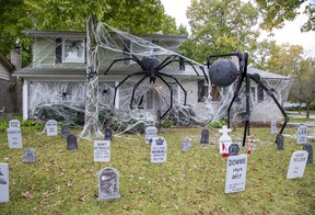 Decorations of large spiders and celebrity tombstones at 45 Blue Ridge Cres., are a labour of love for Dan Earle. (DEREK RUTTAN, The London Free Press)