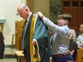 Dr. David Cruise Malloy is vested by King's University College students' council president Hailley White during his installation as the school's ninth principal. The ceremony took place in The Chapel at Windermere Mount in London, Ont. on Wednesday October 16, 2019. Derek Ruttan/The London Free Press/Postmedia Network