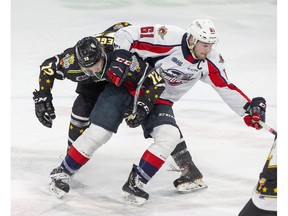 London Knights Alec Regula gets tied up with Luke Book of the  Windsor Spitfires in the first period of their game in London. (Derek Ruttan/The London Free Press)