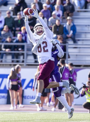 Ottawa Gee Gee Carter Matheson makes a catch while covered by Western Mustang Kojo Odoom during their game in London, Ont. on Saturday October 19, 2019. Derek Ruttan/The London Free Press/Postmedia Network