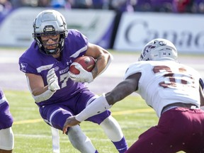 Western Mustangs ball carrier Cole Majoros cuts around Mike Miller of the Ottawa Gee Gees during their game in London, Ont. on Saturday October 19, 2019. (Derek Ruttan/The London Free Press)
