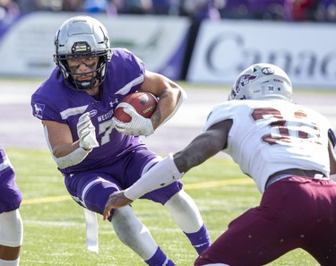 Western Mustangs ball carrier Cole Majoros cuts around Mike Miller of the Ottawa Gee Gees during their game in London, Ont. on Saturday October 19, 2019. Derek Ruttan/The London Free Press/Postmedia Network