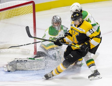 Kingston Frontenac Shane Wright slips on the puck in front of London Knights goalie Brent Brochu while covered by Luke Evangelista in the third period of their game in London, Ont. on Saturday October 19, 2019. Derek Ruttan/The London Free Press/Postmedia Network