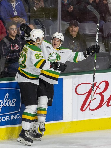 Luke Evangelista celebrates his third goal of the game with London Knights teammate Hunter Skinner during the third period of their game against the Kingston Frontenacs  in London, Ont. on Saturday October 19, 2019. Derek Ruttan/The London Free Press/Postmedia Network