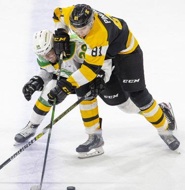 London Knight Ryan Merkley battles Kingston Frontenac Vitali Pinchuk in the third period of their game in London, Ont. on Saturday October 19, 2019. Derek Ruttan/The London Free Press/Postmedia Network