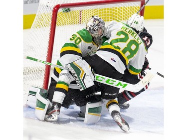 London Knight Ryan Merkley and Niagara Ice Dog Cameron Snow crash into Knights goalie Brett Brochu during the first period of their OHL hockey game at Budweiser Gardens on Sunday Oct. 27, 2019. Derek Ruttan/The London Free Press