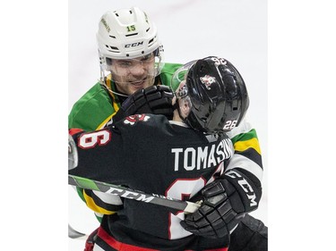 London Knight Cole Tymkin tangles with Niagara Ice Dog Philip Tomasino  during the first period of their OHL hockey game at Budweiser Gardens on Sunday Oct. 27, 2019. Derek Ruttan/The London Free Press