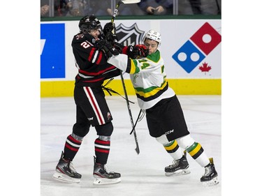 Niagara Ice Dog Andrew Bruder gets physical with London Knight Ben Roger during the second period of their OHL hockey game at Budweiser Gardens on Sunday Oct. 27, 2019. Derek Ruttan/The London Free Press