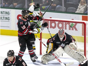 Niagara Ice Dog defenseman Mason Howard ties up London Knight Jonathan Gruden in Christian Sbaraglia's crease during the third period of their OHL hockey game at Budweiser Gardens on Sunday Oct. 27, 2019. Derek Ruttan/The London Free Press