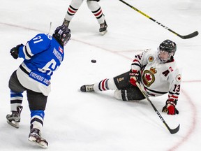 London Nationals sniper Max Vinogradov firess a shot toward the Sarnia Legionnaires net Thursday during a Jr. ‘B’ hockey contest at Sarnia Arena. Vinogradov scored three times to lead the Nats to a 10-4 win. Sarnia forward Joe Ferrera is shown going down as he attempts a shot block. Photo taken Thursday Oct. 18, 2019. Photo by Shawna Lavoie