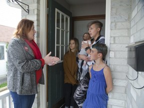 Elgin-Middlesex-London Liberal Party candidate Pam Armstrong (left) speaks with Kait Foote and here three daughters L to R Marlee (10), Laikyn (8 weeks) and Mila 7 while campaigning door-to-door in St. Thomas. Derek Ruttan/The London Free Press