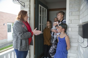 Elgin-Middlesex-London Liberal Party candidate Pam Armstrong (left) speaks with Kait Foote and here three daughters L to R Marlee (10), Laikyn (8 weeks) and Mila 7 while campaigning door-to-door in St. Thomas. Derek Ruttan/The London Free Press