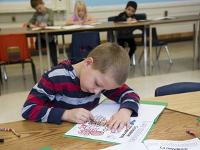 Grade two student Tommy Trebicky (7) colours a title page in science class at Jeanne Sauve French Immersion Public School. Derek Ruttan/The London Free Press/Postmedia Network