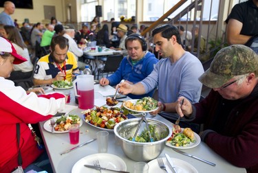 London North Centre Liberal candidate Peter Fragiskatos helps fill up a plate as candidates in the riding had supper at the Sanctuary on Talbot Street. Mike Hensen/The London Free Press