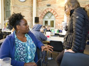 London North Centre NDP candidate Dirka Prout talks to Kim Ryan at her table during a weekly supper at the Sanctuary on Talbot Street. Mike Hensen/The London Free Press