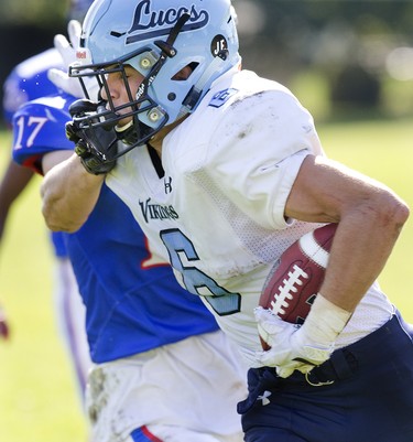 Lucas Vikings ball carrier Will Adam gets face full of fingers from Jacob Slade of the Oakridge Oaks during their football game at Lucas in London, Ont. on Thursday Oct. 10, 2019. The home team won the game 48-6. Derek Ruttan/The London Free Press