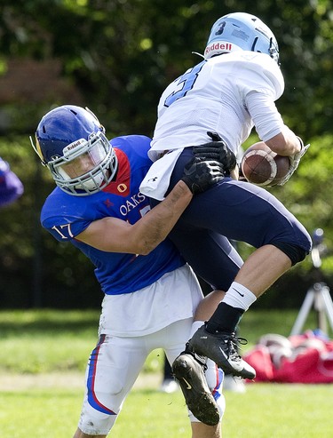 Oakridge Oak Jacob Slade corrals Lucas Viking Mack Baker after he leapt to grab a blocked Oakridge punt during their football game at Lucas in London, Ont. on Thursday Oct. 10, 2019. The home team won the game 48-6. Derek Ruttan/The London Free Press