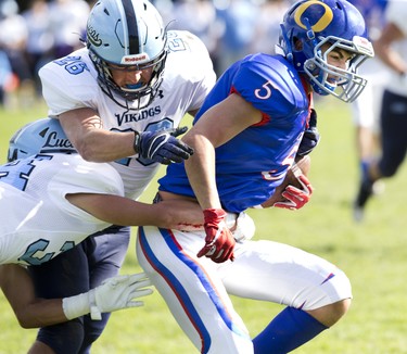 Oakridge Oaks ball carrier Mony Madlol is stopped by four Lucas Vikings including Zach Hepburn (34) and Thomas Ashton (26) during their football game at Lucas in London, Ont. on Thursday Oct. 10, 2019. The home team won the game 48-6. Derek Ruttan/The London Free Press