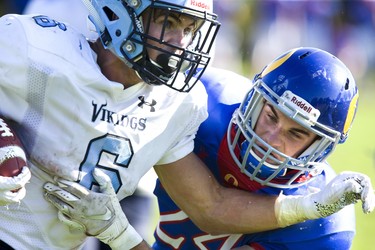 Lucas Vikings ball carrier Will Adam is grabbed by Richard Bain of the Oakridge Oaks during their football game at Lucas in London, Ont. on Thursday Oct. 10, 2019. The home team won the game 48-6. Derek Ruttan/The London Free Press