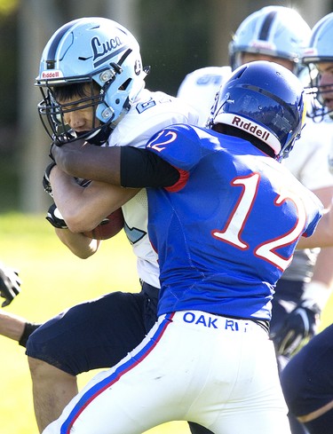 Lucas Vikings ball carrier Jason Huynh is stopped in his tracks by Tisal Dayaratna of the Oakridge Oaks during their football game at Lucas in London, Ont. on Thursday Oct. 10, 2019. The home team won the game 48-6. Derek Ruttan/The London Free Press