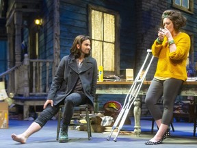 Jimmy, played by Allister MacDonald, has his recently broken leg tested by the foot of neighbourhood foster mom Mrs. Simpson, played by Rebecca Northan, in the world premiere of the Grand Theatre's This London Life, written and directed by Morris Panych.  (Mike Hensen, The London Free Press)