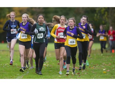 Suraya Byam of Mother Teresa secondary school leads the junior girls TVRA cross-country final at Springbank Park on Thursday Oct. 17, 2019. Byam was among three Central secondary school runners as the race went on, and managed a strong second behind Central's Rebecca Christensen, right,  behind teammate #388 Laine Barnfield (Mike Hensen/The London Free Press)