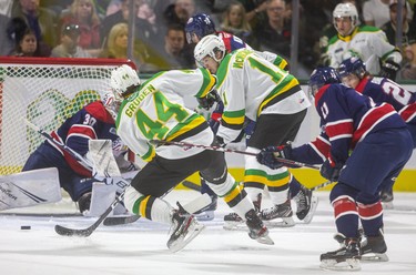 Jonathan Gruden and Connor McMichael of the Knights try to take advantage of the hard work of Luke Evangelista in the corners during the first period of their game Friday night at Budweiser Gardens in London, Ont.  Photograph taken on Friday October 25, 2019.  Mike Hensen/The London Free Press/Postmedia Network