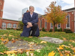 London historian Joseph O'Neil shows where the old cemetery at St. Paul's cathedral still has some markers, and O'Neil says bodies are still buried on the site in London, Ont.   (Mike Hensen/The London Free Press)