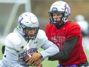 Western running back Trey Humes takes the handoff from quarterback Chris Merchant during practice ahead of Saturday's Yates Cup semifinal clash with the Waterloo Warriors. (Mike Hensen/The London Free Press)