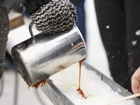 Maple syrup is poured onto snow in this 2015 file photo.