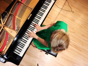 Brenda Earle Stokes, a New York-based jazz musician originally from Sarnia, is shown in his photo by Petrolia's Dawson Currie playing the grand piano at the Sarnia Library Theatre. It's where she recorded her new album, Solo Sessions Volume 1.