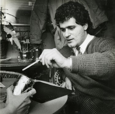 Vince Barletta, owner of Beef Baron takes part in fortune telling session, 1987. (London Free Press files)