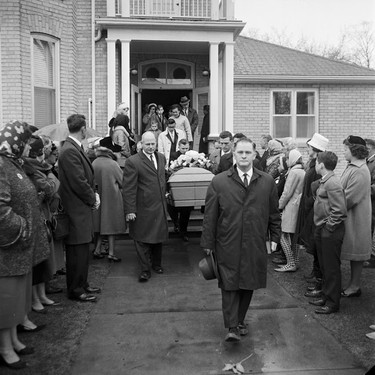 The coffin of Georgia Jackson, who went missing Feb. 18, 1966, on her walk home after a shift at a dairy bar in Aylmer, is carried away after the funeral service. Jackson's battered body was found in a wooded area on Springfield Road a few miles from her home on March 16, 1966. She had been raped, beaten and strangled. (London Free Press Collection of Photographic Negatives (1968-04-15), Archives and Special Collection, Western Libraries, Western University.)