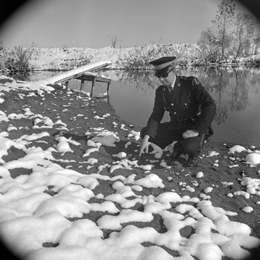 OPP Constable Henry Harley Heal points to the spot where Jackie English's shoes were found. (London Free Press Collection of Photographic Negatives (1968-04-15), Archives and Special Collection, Western Libraries, Western University)