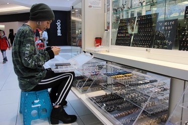 Talon LeBlanc, 23, works at a piercing stand at White Oaks Mall in London. A recent report by city hall shows London has a large percentage of youth between the ages of 15 and 29 neither working nor studying. JONATHAN JUHA/The London Free Press