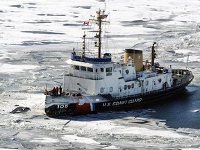Unidentified debris from a plane sits above the ice, left, as the U.S. Coast Guard Cutter Neah Bay posts itself Sunday outside of the site where a charter flight from Pelee Island to Windsor Airport crash-landed about a half-a-mile off the island into Lake Erie, killing 10 people. Photo taken in January 2004 (Tim Fraser/Windsor Star)