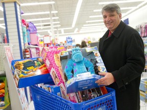 Leo Larizza pushes a cart full of toys through Toys 'R' Us as he shops for Christmas gifts in this 2013 Free Press photo.