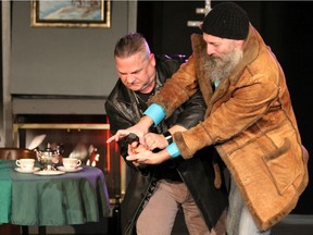 David Pasquino, left, and Brett McKenzie, who plays Rasputin in Party in Petrograd: The Last Hours of Rasputin, wrestle over a gun during a dress rehearsal at the Tap Centre for Creativity at 203 Dundas St. on Tuesday. The play, written and directed by Jason Rip, opens Wednesday. (DALE CARRUTHERS, The London Free Press)