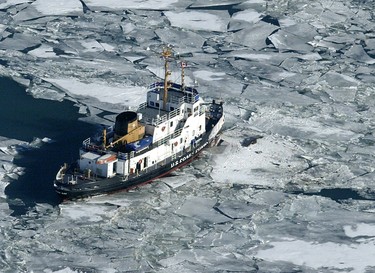 The US Coast Guard Cutter Neah Bay posts itself outside of the site where a charter flight from Pelee Island to Windsor Airport crash-landed on January 17, 2004 about a half-a-mile off the island into Lake Erie, killing 10 people. (Tim Fraser/Windsor Star)