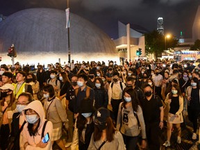 People geather and march to show support for a small group of protesters barricaded for over a week inside the Hong Kong Polytechnic University campus in Tsim Sha Tsui district in Hong Kong on November 25, 2019. - Hong Kong's deeply unpopular leader vowed on November 25 to "listen humbly" to voters after the pro-democracy camp scored a crushing victory in community-level elections that revealed broad public support for a protest movement that has stirred months of violence. (Photo by YE AUNG THU / AFP)