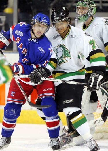 London Knight Akim Alie ties up Kitchener Ranger Nic Spaling in front of Knights goali Steve Mason in the first period at the JLC.