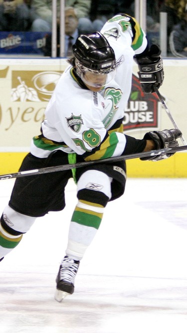 London Knights forward Akim Aliu tries to carry the puck past Jake Carrick of the Soo Greyhounds during the first period of their game Thursday night at the John Labatt Centre.