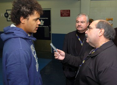 London Knights player Akim Aliu translates for Russian coach Vladimir Plyuschev during an interview with Morris Dalla Costa following practice at the Western Fair Sports Centre Monday.