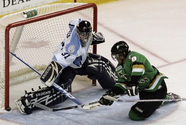 Close, but . . . : A shot by London Knights forward Akim Aliu hits the post behind Mississauga St. Michael’s Majors goalie Anthony Grieco during the second period of last night’s game at the John Labatt Centre. The Knights won 3-2 in a shootout.