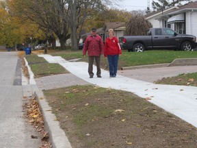 John and Shirley Wilson are among the residents of Coverdale Street who are not happy with the undulations in a sidewalk that was recently installed in the north Chatham neighborhood. They are seen here Wednesday standing in a dip in the sidewalk in front of their house. Ellwood Shreve/Chatham Daily News/Postmedia Network