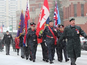 Participants in the Remembrance Day parade begin their route outside the Delta Armouries hotel -- at one time the London Armouries -- before marking their way to the cenotaph in Victoria Park on Monday, Nov. 11. (DALE CARRUTHERS, The London Free Press)