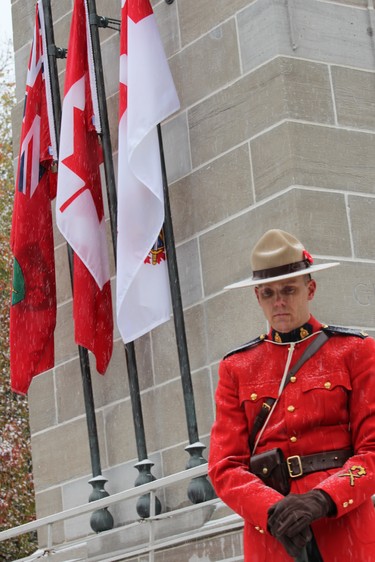 An RCMP officer stands guard at the cenotaph in Victoria Park during the Remembrance Day ceremony on Monday, Nov. 11, 2019. (DALE CARRUTHERS, The London Free Press)