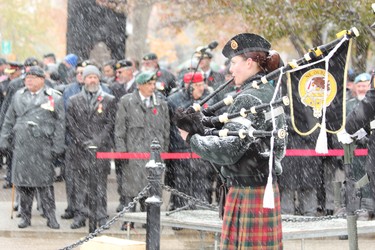 A woman plays the bagpipes at the cenotaph in Victoria Park during the Remembrance Day ceremony on Monday, Nov. 11, 2019. (DALE CARRUTHERS, The London Free Press)