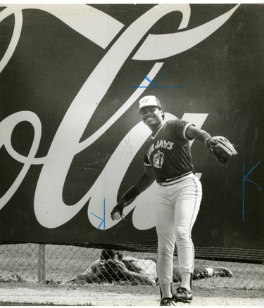 Jessie Barfield, Toronto Blue Jay outfielder, photographer shooting through the bottom of the fence at spring training, 1987. (London Free Press files)